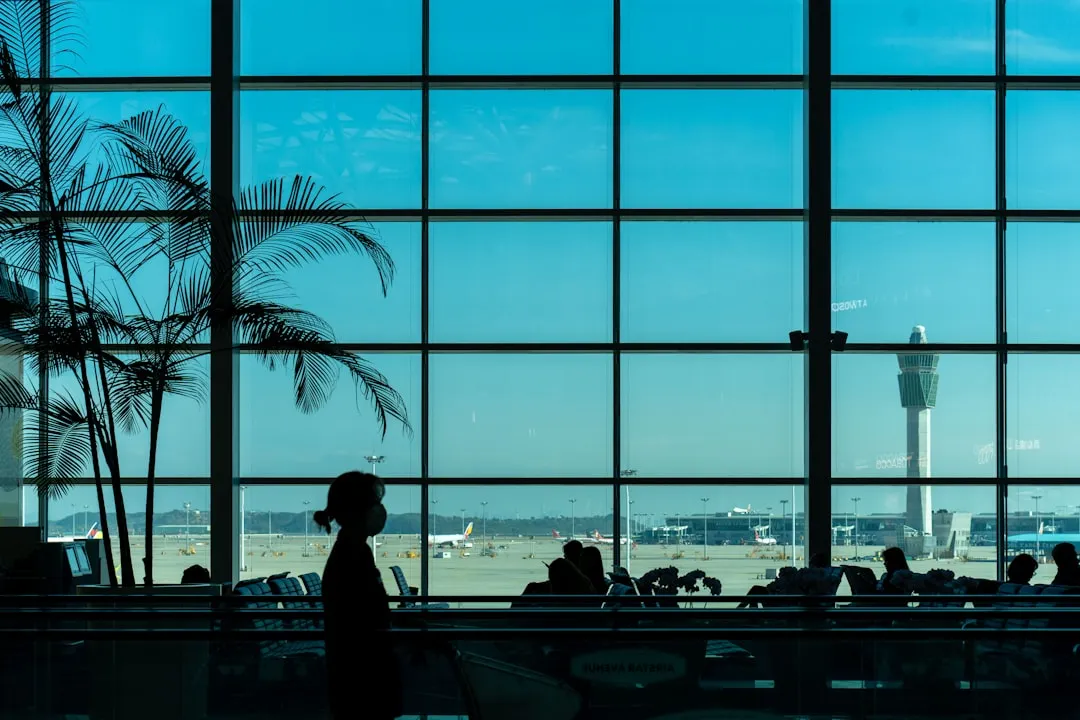 A person looks out of an airport window.