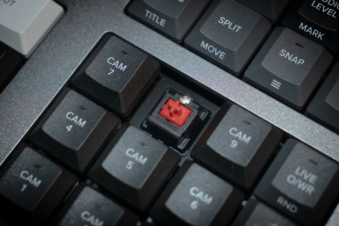 a close up of a keyboard with a red light on it