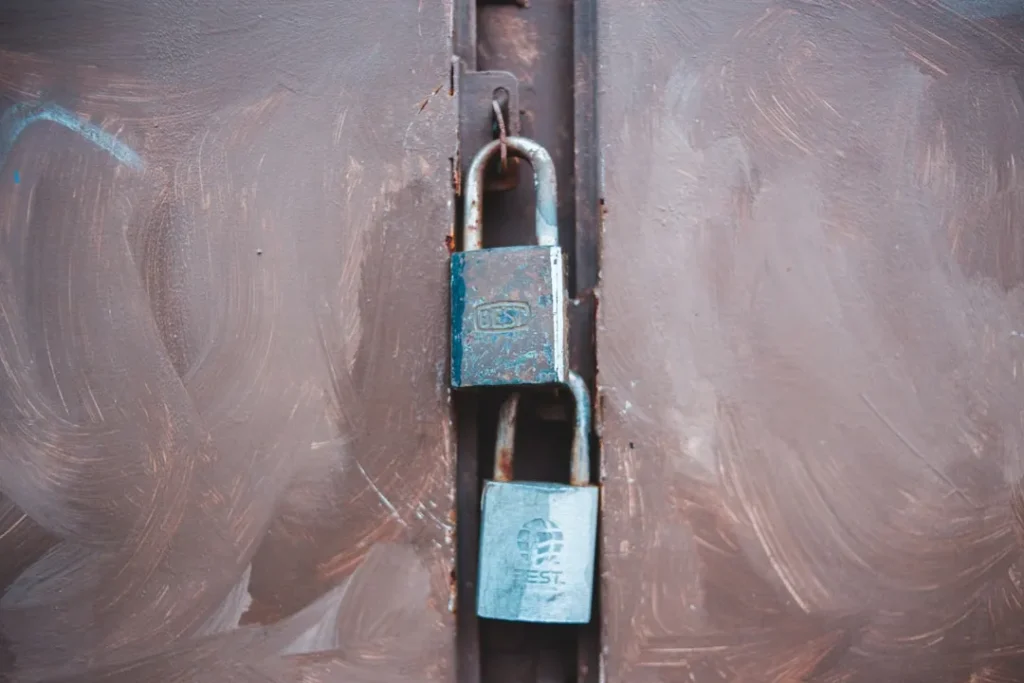black and silver padlock on white plastic